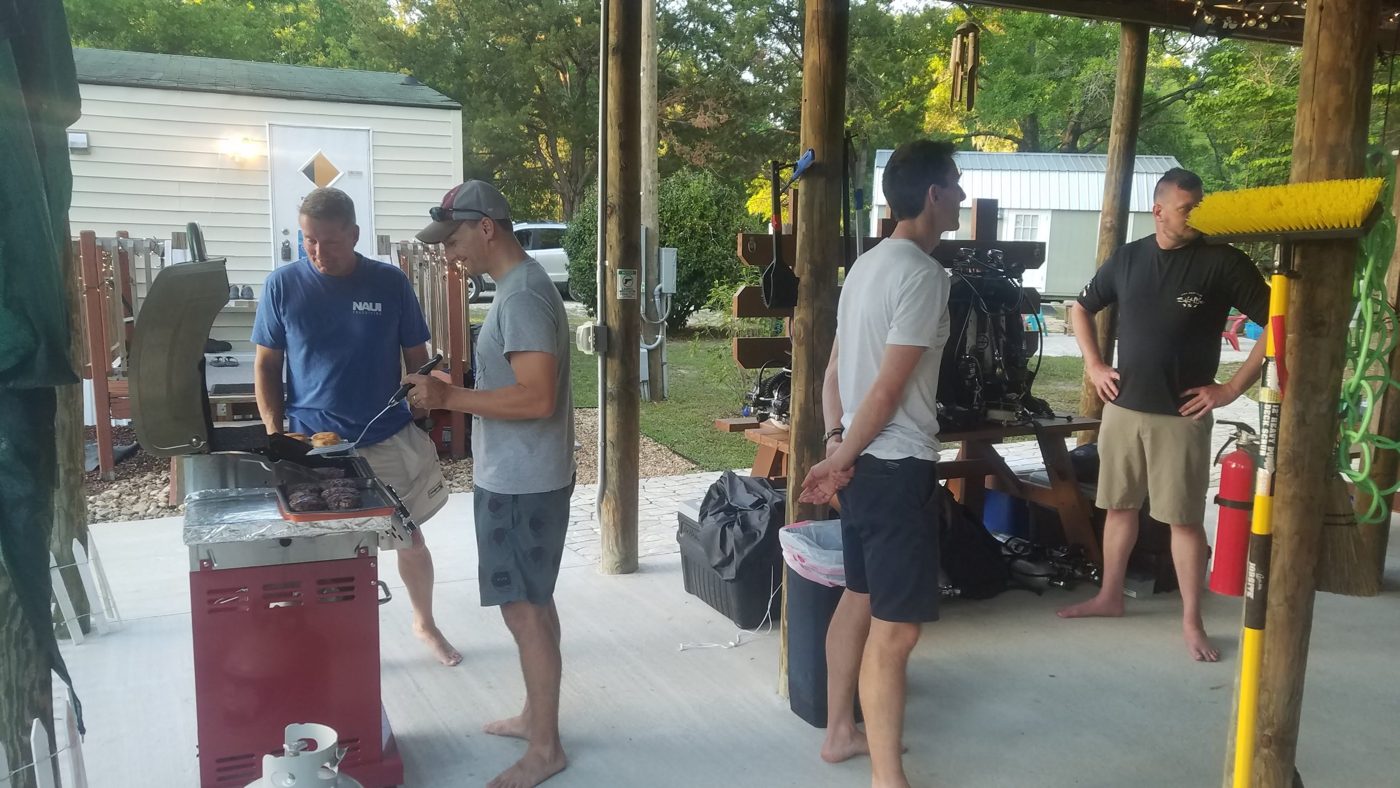 Divers grilling under the pavilion