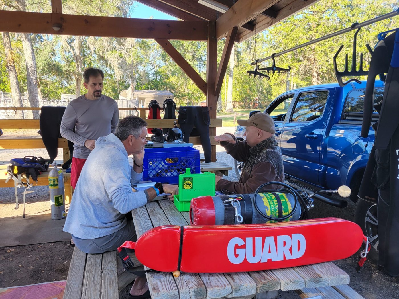 Dive briefing at a picnic table with a rescue can
