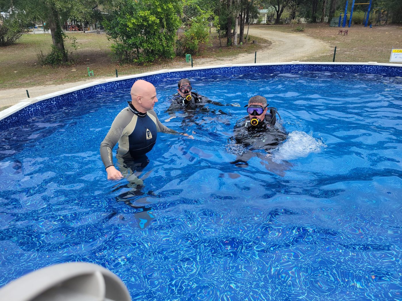 Joe working with two students in the Lodge's training pool